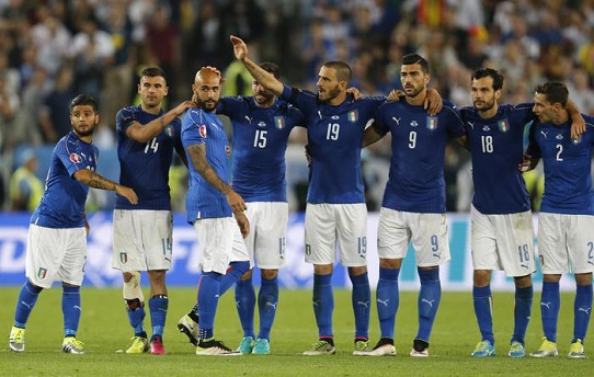 Italy's Siimone Zaza is comforted by his teammates after failing to score in the penalty shoot out of the Euro 2016 quarterfinal soccer match between Germany and Italy, at the Nouveau Stade in Bordeaux, France, Saturday, July 2, 2016. (ANSA/AP Photo/Michael Probst)